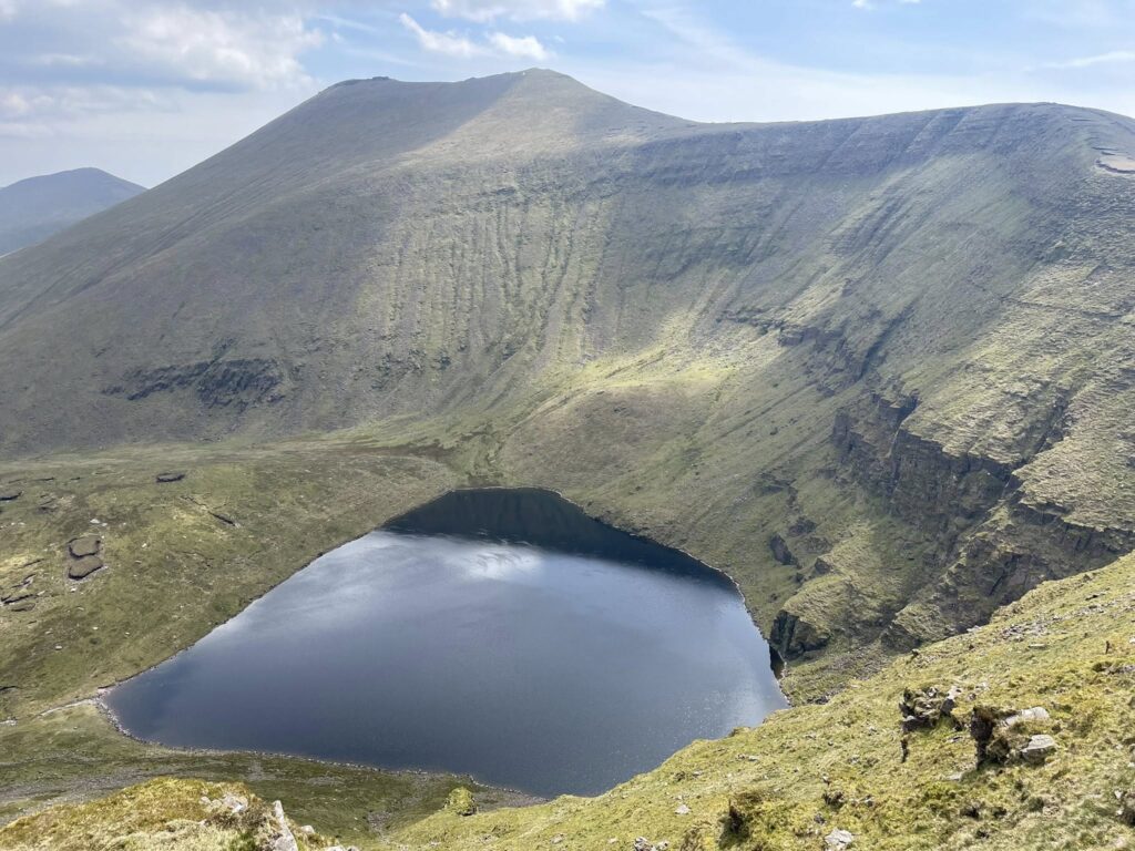 May be an image of lake, crater and mountain